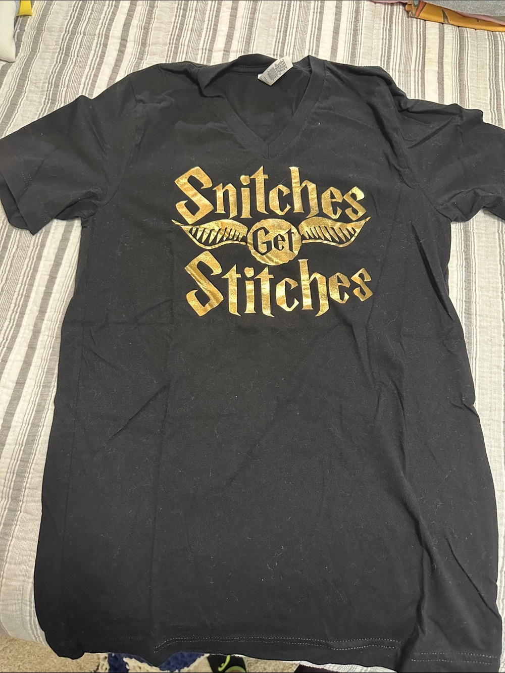 Black V-Neck Men’s Tee with Gold 'Snitches Get Stitches' Graphic